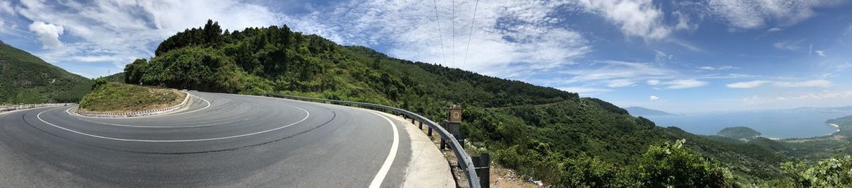 Panoramic view of road amidst mountains against sky