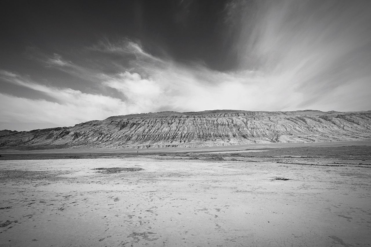 tranquil scene, tranquility, sky, mountain, scenics, beauty in nature, landscape, nature, mountain range, cloud - sky, cloud, non-urban scene, water, remote, idyllic, sand, day, cloudy, outdoors, no people