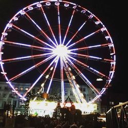 Low angle view of ferris wheel at night