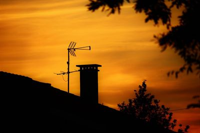 Low angle view of silhouette trees against sky at sunset