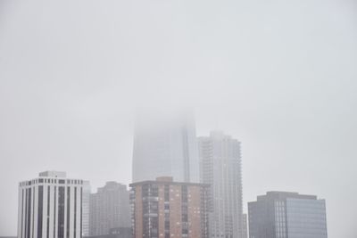 Skyscrapers in city against clear sky