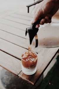 Cropped image of hand holding coffee cup