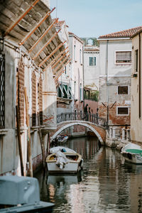 Bridge over canal amidst buildings in city