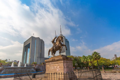 Low angle view of statue against cloudy sky