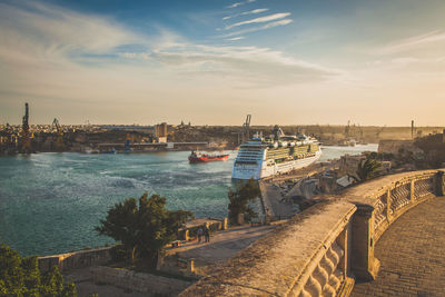 Cruise ship on river against sky