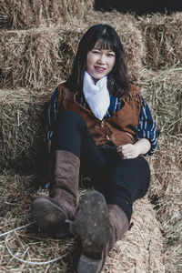 Full length of woman sitting on field