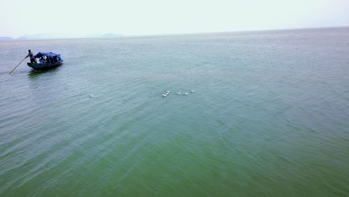 High angle view of boat sailing on sea against sky