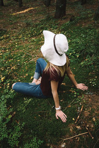 Full length of woman sitting in forest