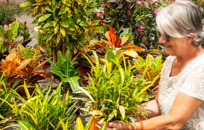 Senior woman gardening in community garden