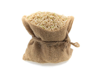 High angle view of bread in basket against white background