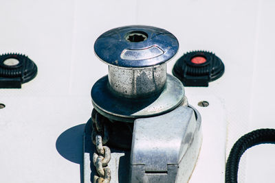 Close-up of machine part against wall
