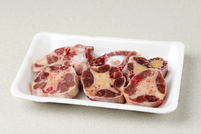 Raw oxtail on styrofoam plate, isolated