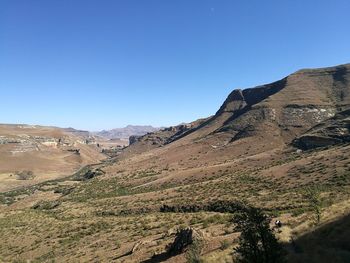 Scenic view of mountains against clear blue sky