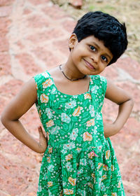 Portrait of smiling boy standing against wall