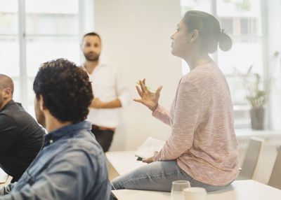 Confident student explaining while sitting in language class