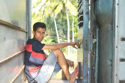 Side view full length of man traveling in train