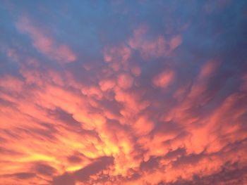 Low angle view of cloudy sky at sunset