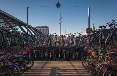 Bicycles parked at station against clear sky