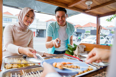 Portrait of smiling woman working at table