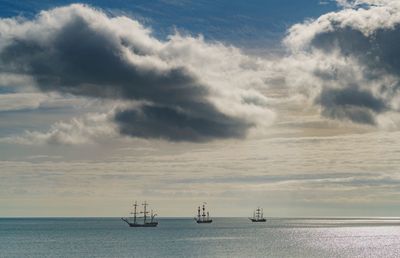 Boats sailing in sea against sky