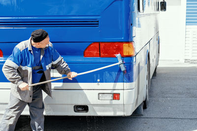 Rear view of man working at railroad station