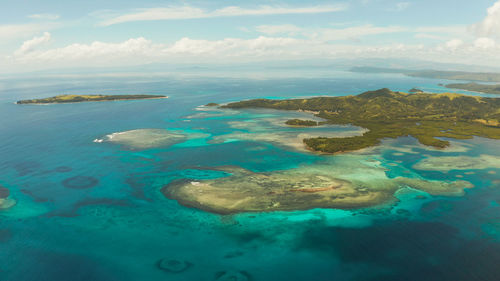 Tropical islands with beaches and azure coral reef water from above. bucas grande, philippines