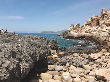 Rocks on beach against sky