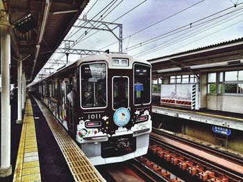 Train at railroad station against sky