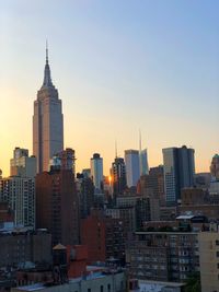 View of buildings in city against clear sky