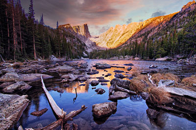 Dramatic dawn light reflected in beautiful dream lake in rocky mountain national park, colorado