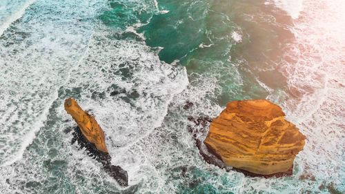 High angle view of rock in sea