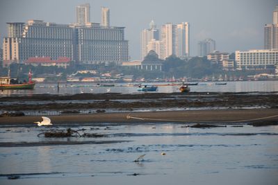View of sea and buildings in city