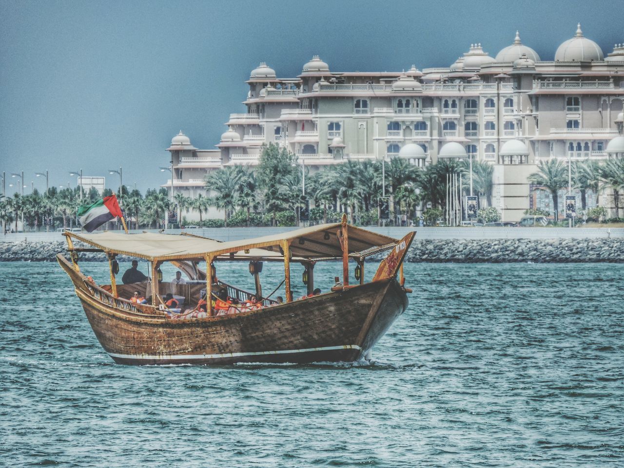 water, architecture, built structure, building exterior, nautical vessel, waterfront, boat, transportation, mode of transport, sea, moored, rippled, clear sky, travel, day, incidental people, outdoors, travel destinations, river, sky