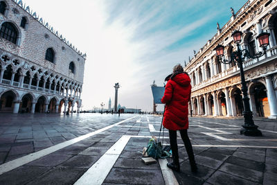 People walking in front of historical building