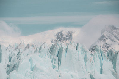 Panoramic view of snowcapped mountains against sky