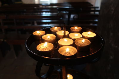 Close-up of lit tea light candles on table