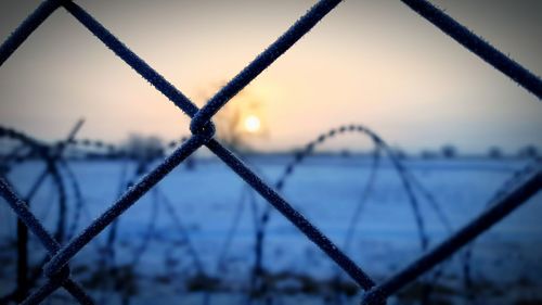 Close-up of fence against sky