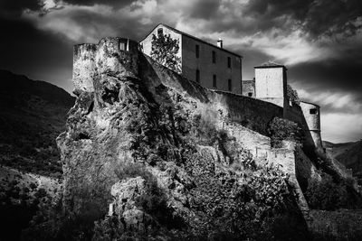 Low angle view of abandoned building against sky