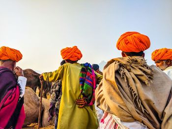 Camel traders negotiating on the prices of their camels. pushkar, rajasthan, india. 