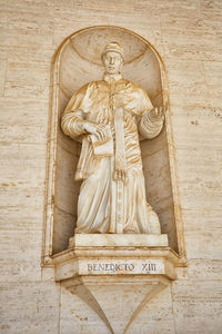 Statue of buddha against wall