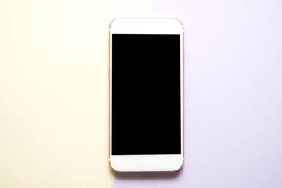 Close-up of smart phone against white background