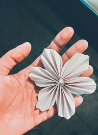 Close-up of hand holding artificial flower