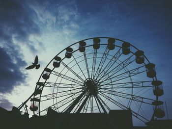 Low angle view of ferris wheel against sky