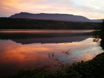 Scenic view of lake against orange sky