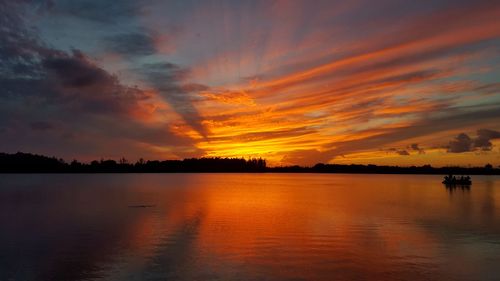 Scenic view of lake at sunset