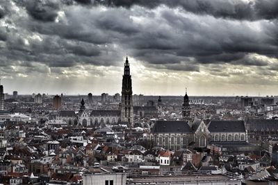 View of cityscape against cloudy sky