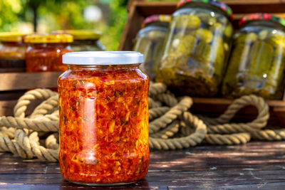 Close-up of coins in jars on table