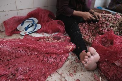 Man with onions sitting on floor