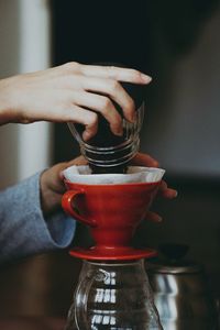 Cropped hands of woman preparing coffee