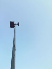 Low angle view of floodlight against clear blue sky